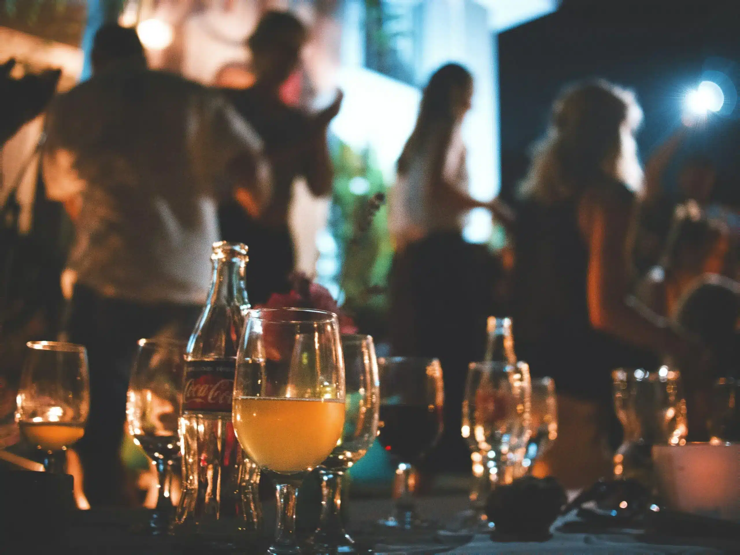 Guests socialising at a candlelit evening event.